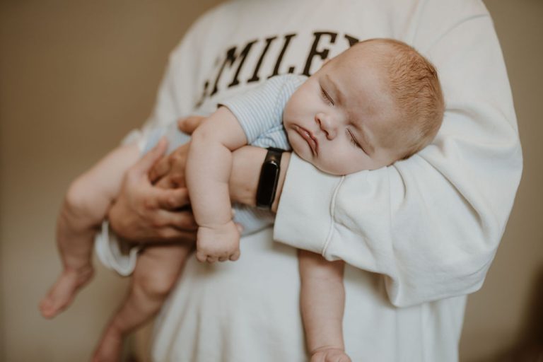 Baby asleep in mum's arms