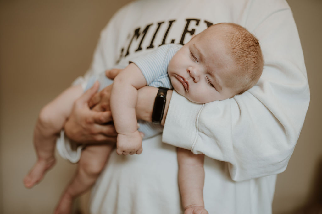 Baby asleep in mum's arms