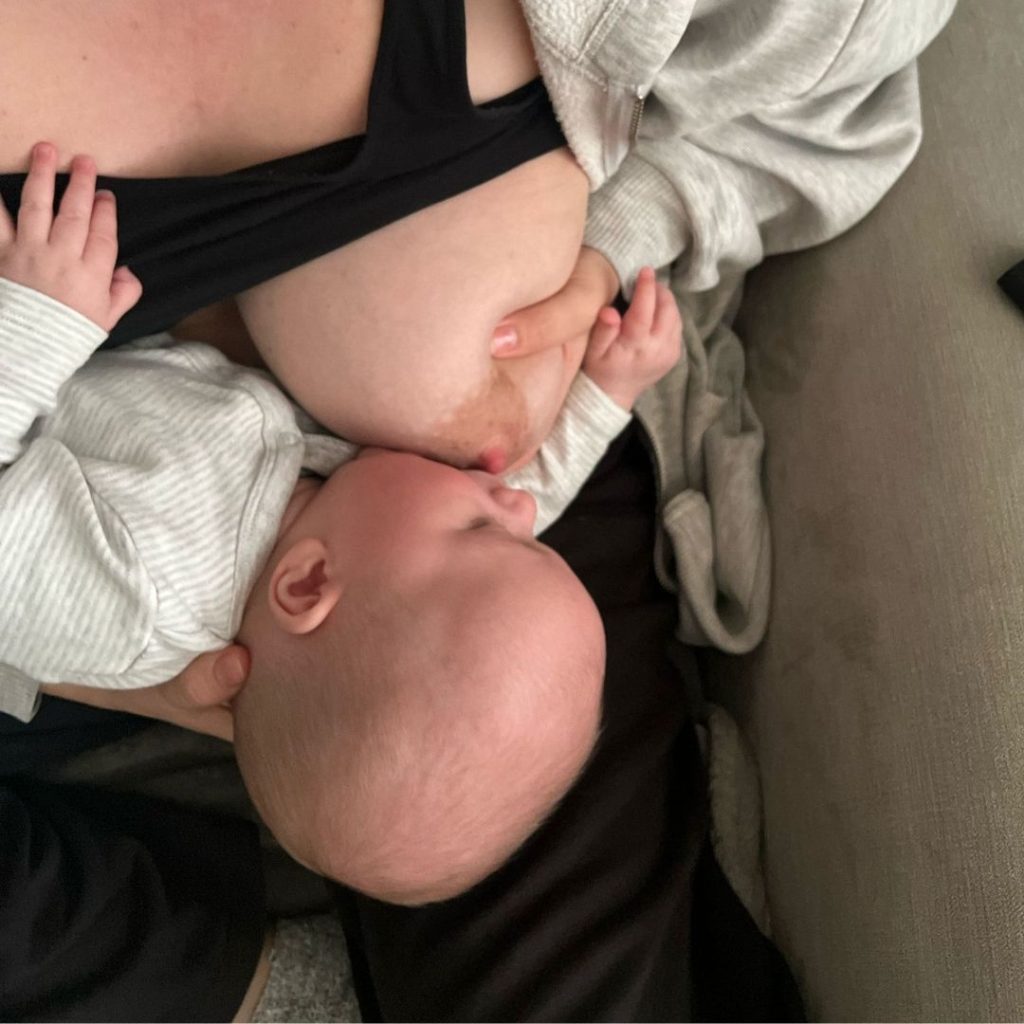 Mum demonstrating latching a baby onto the breast