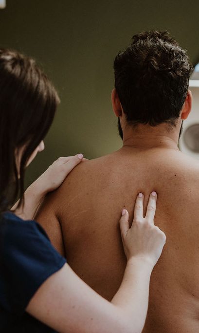 Osteopath Hannah Hilton assessing a male patient